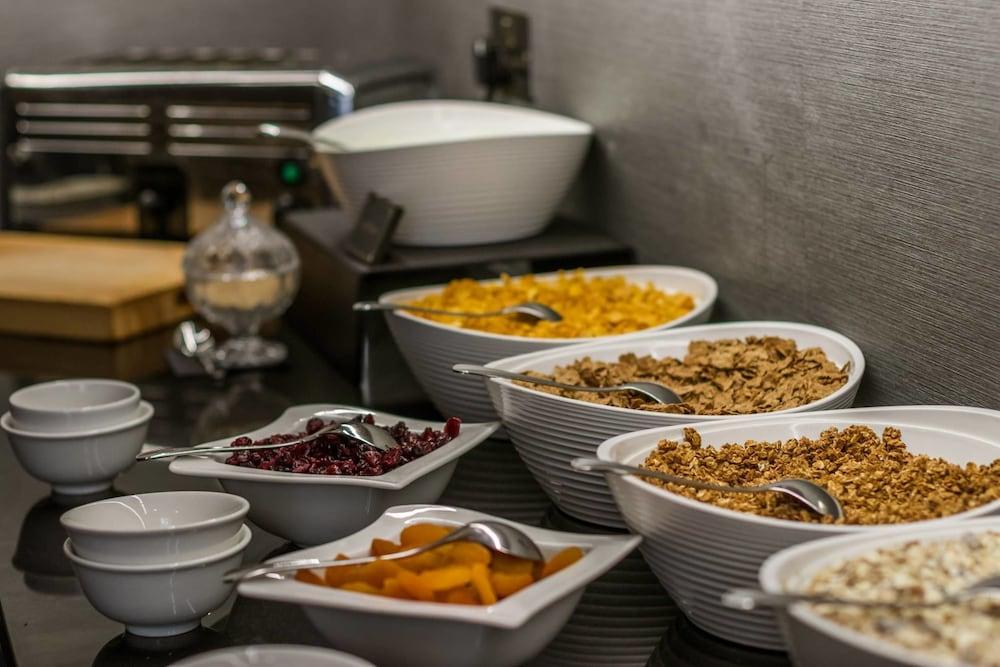 Montcalm Brewery Townhouse Hotel Londen Buitenkant foto The photo shows a variety of food items arranged on a countertop. There are several bowls containing different types of cereals and toppings. 

- One bowl features a light-colored granola.
- Another bowl holds what looks like corn flakes or a similar